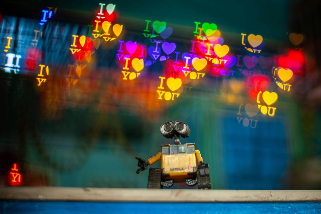 Toy robot with colorful bokeh heart shapes and 